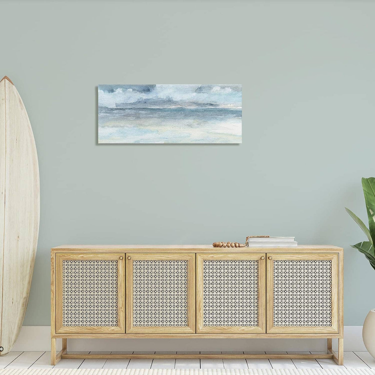 Blue-gray cloudy ocean waves canvas wall art above a woven media console