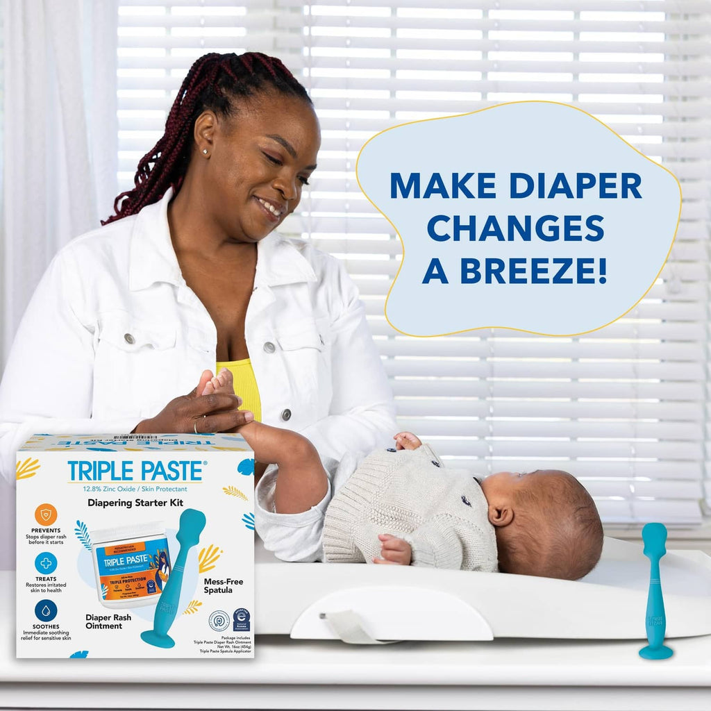 Diaper rash cream starter kit with blue spatula beside baby on changing pad
