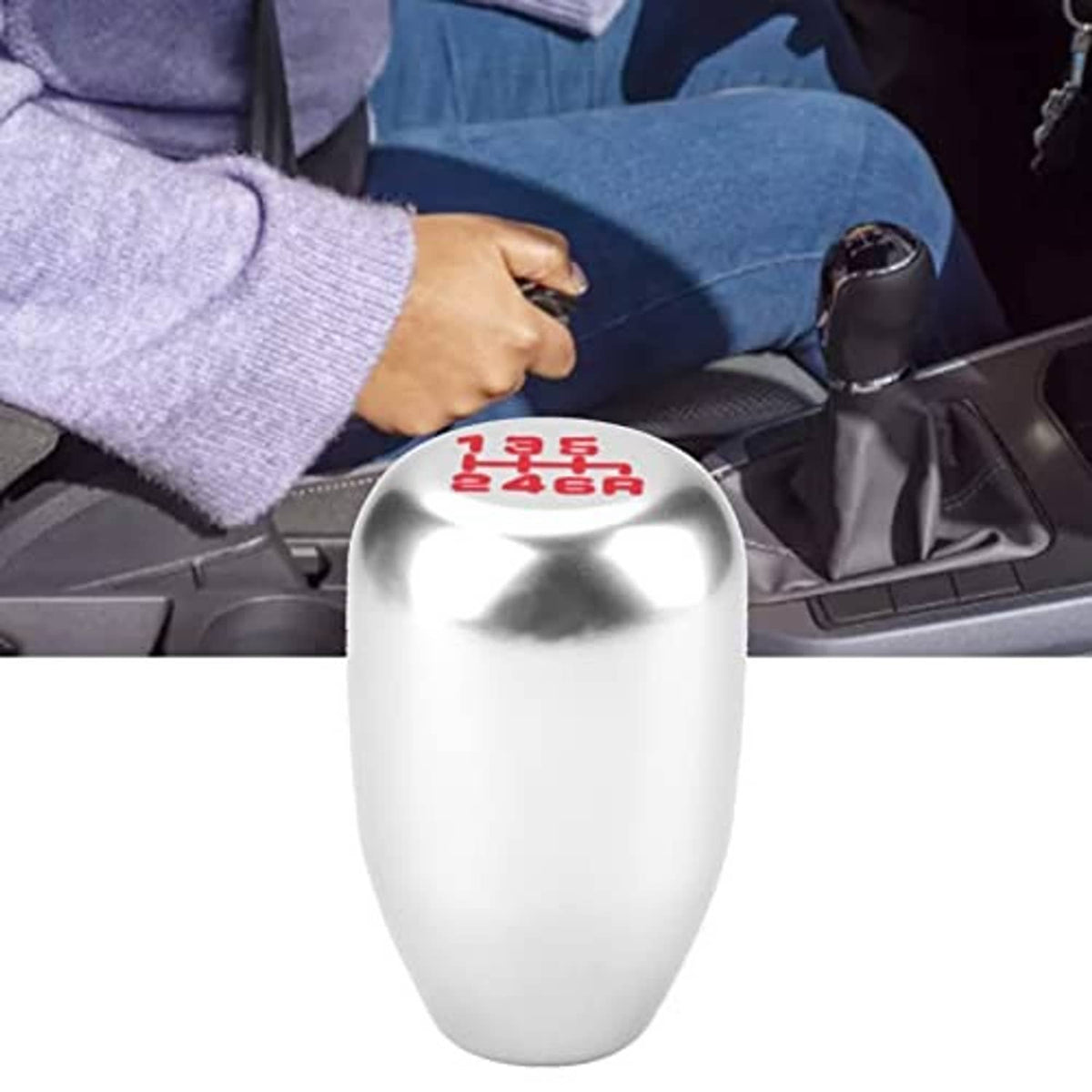 Silver 6-speed manual gear shift knob with red shift pattern on top, installed in a car