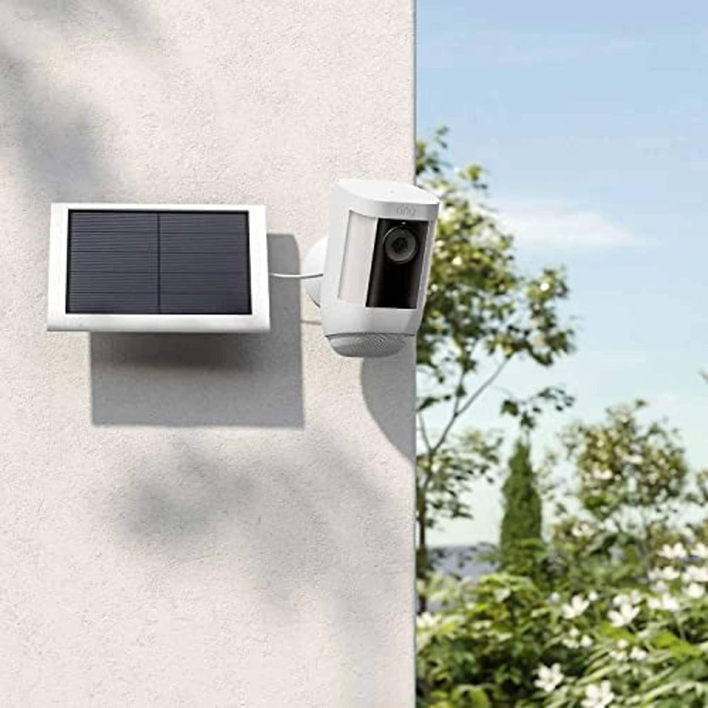 Outdoor wall solar panel with black grid and connected security camera unit