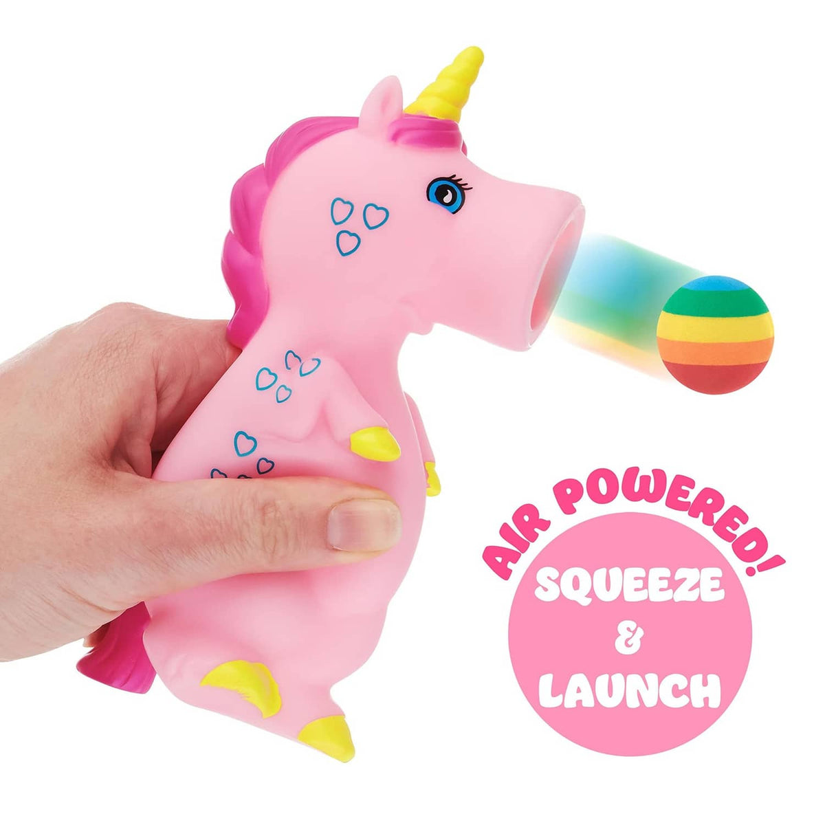 Unicorn foam ball popper toy being squeezed by a hand, launching rainbow foam ball