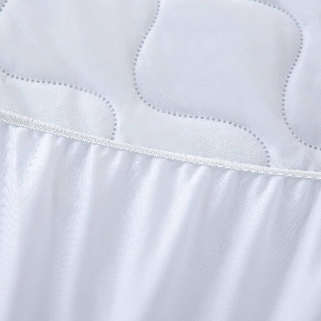 Waterproof mattress protector pad, white stitched hem and dotted quilting pattern