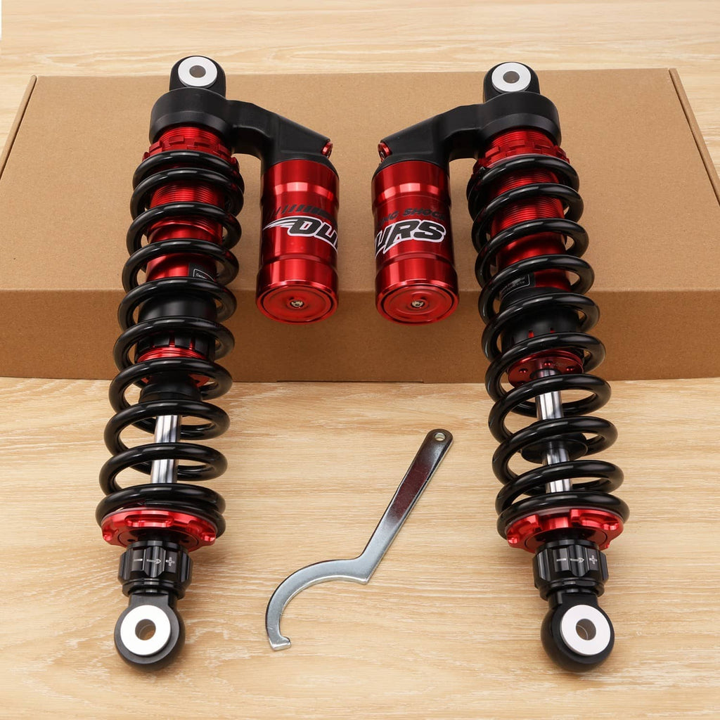 Front shock absorbers pair with red reservoirs, black springs, and mounting wrench