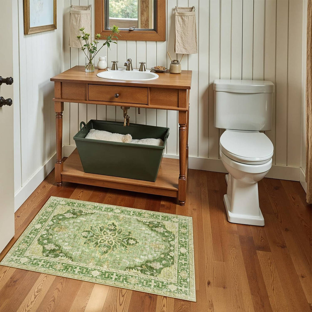 Washable area rug, rectangular green floral medallion pattern on light wood floor