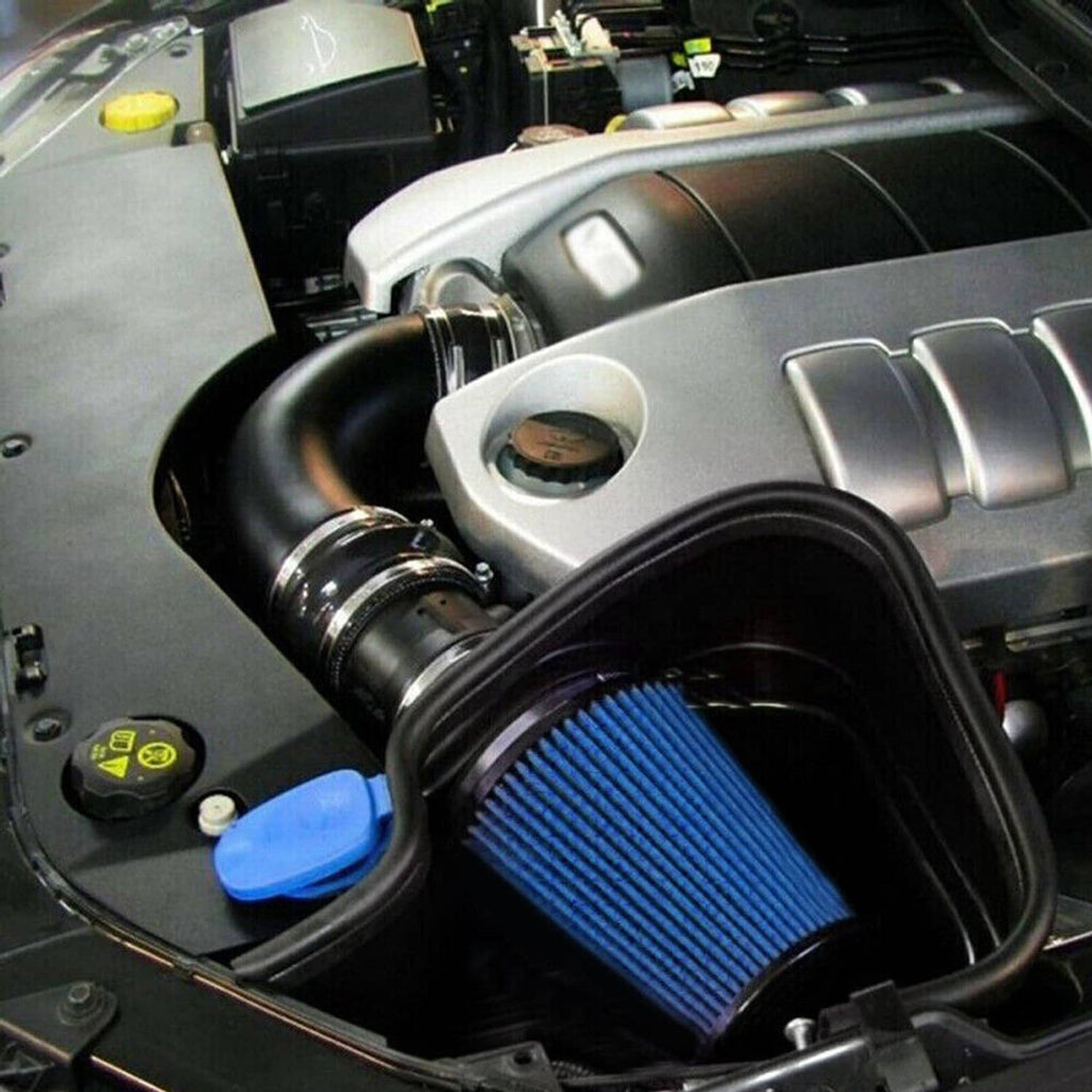 Blue pleated cone air filter installed in engine bay with black intake tube