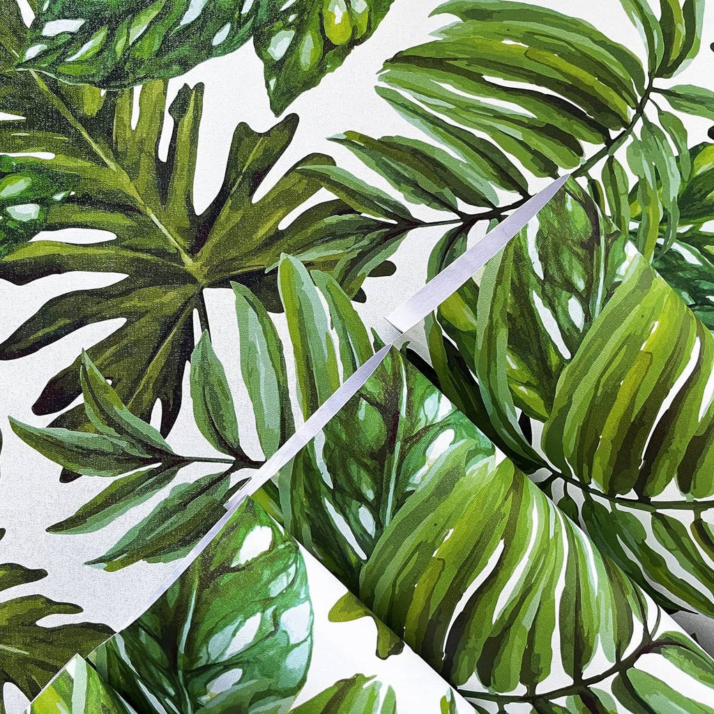 Tropical palm leaf wallpaper detail with layered green and white leaf silhouettes