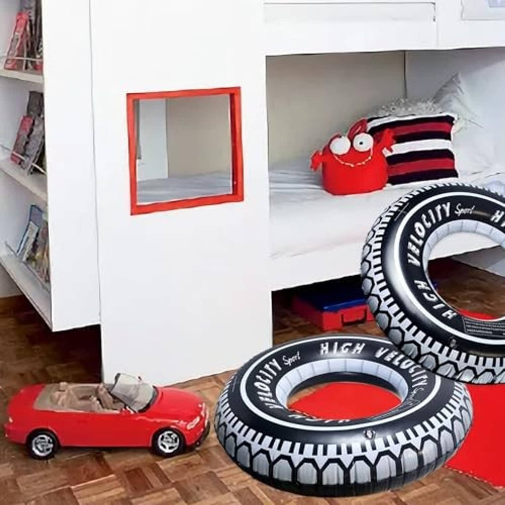Black-and-white inflatable tire pool float ring with “High Velocity” design