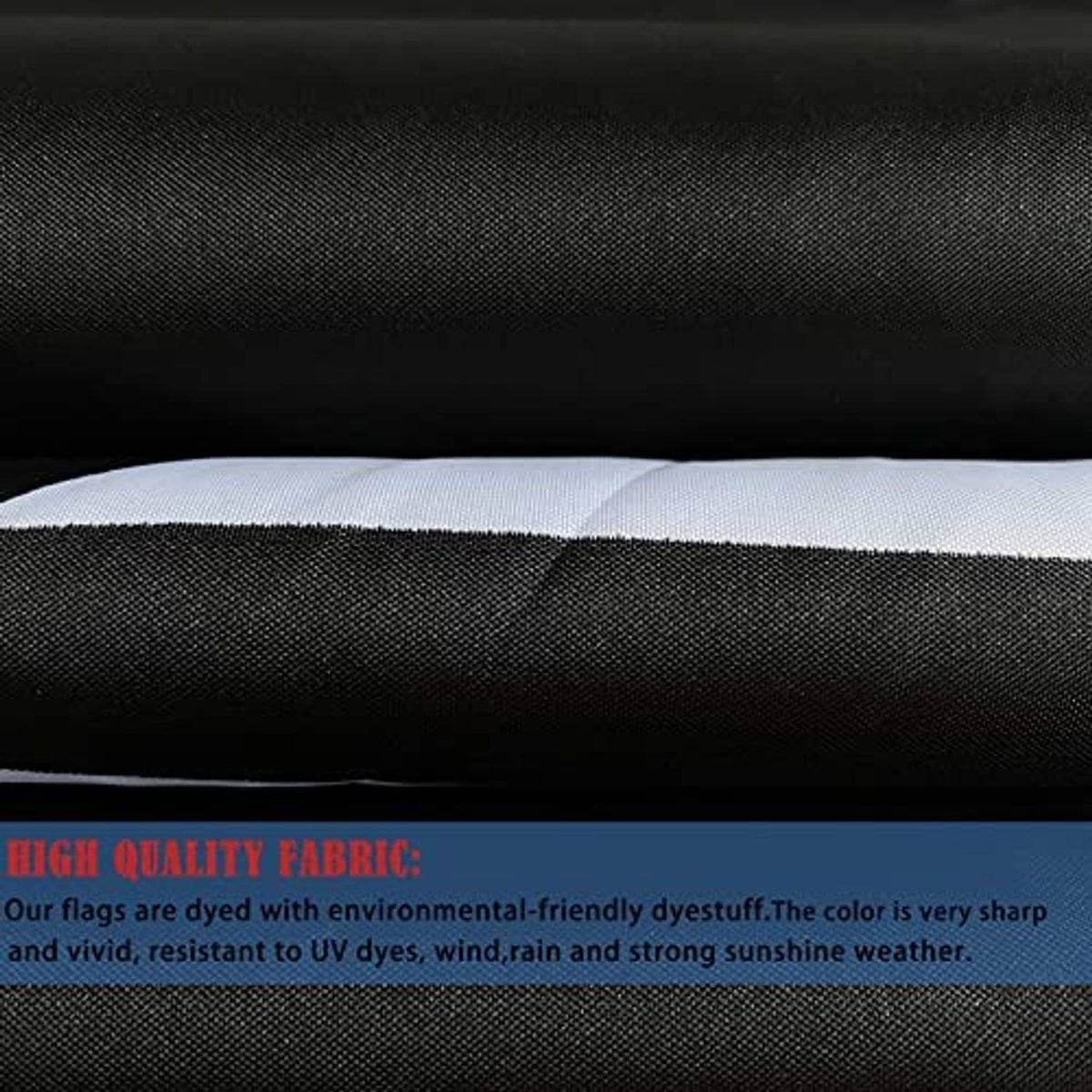 Black flag fabric close-up with textured weave and white stitched edge hem.