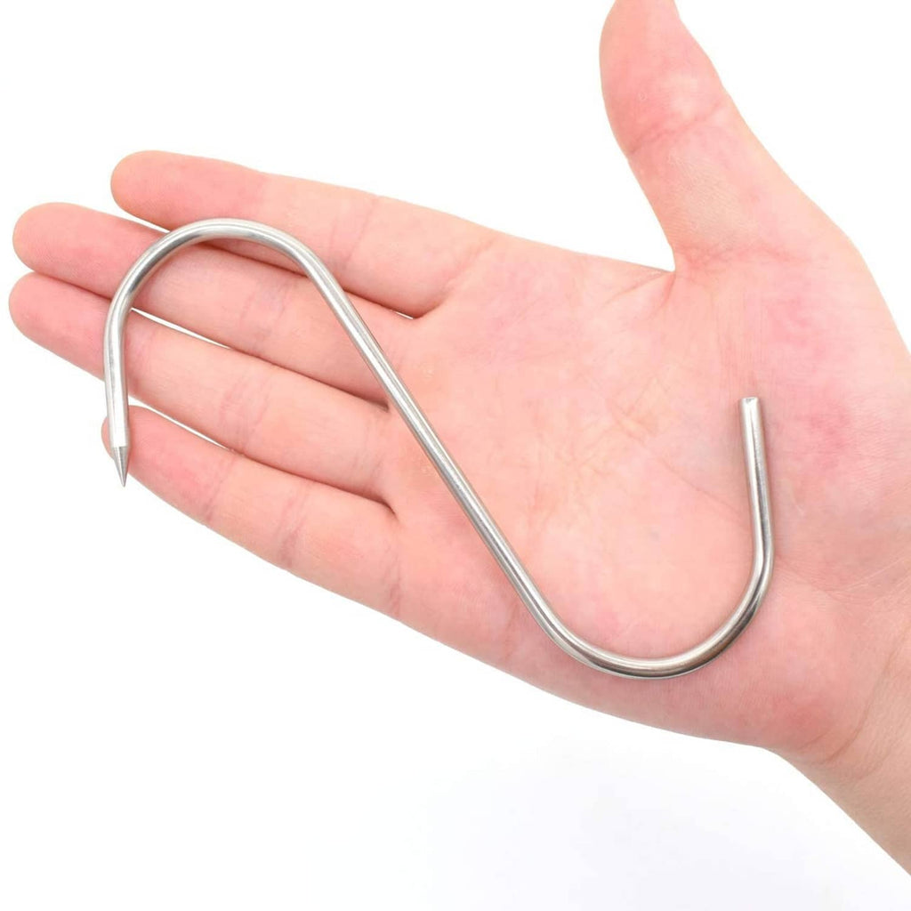 Stainless steel S-hook meat hook held in hand, pointed end facing forward