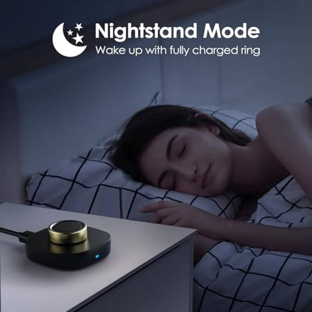Black charging dock with gold ring on bedside table in low-light setting