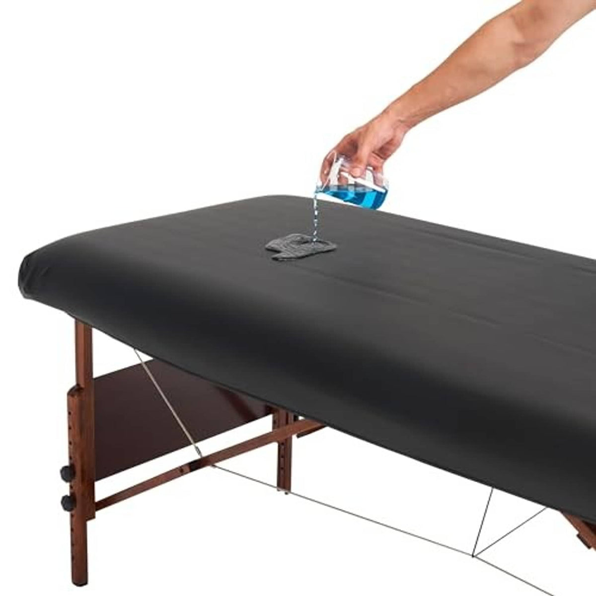 Black PU vinyl massage table cover on wooden frame with feet and top surface