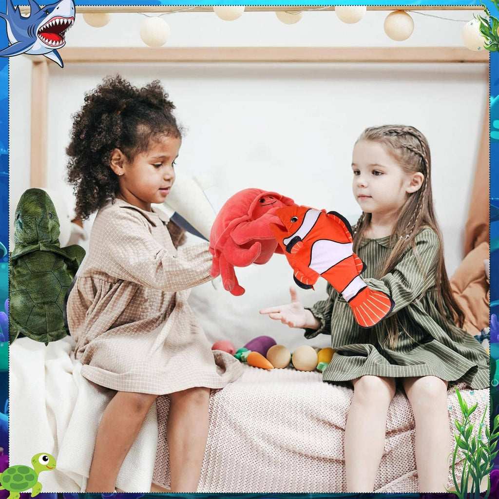 Kids holding orange clownfish and green turtle animal hand puppets