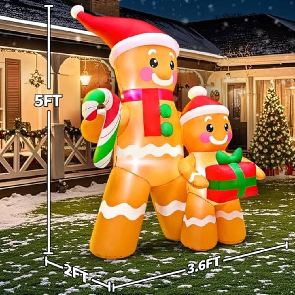 Inflatable gingerbread characters on a snowy lawn, candy cane and wrapped gift in front