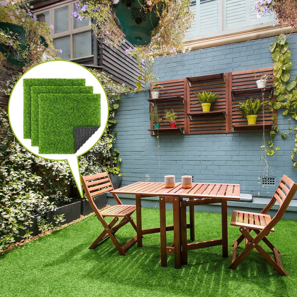 Outdoor green artificial grass mat covering a patio area beside a table