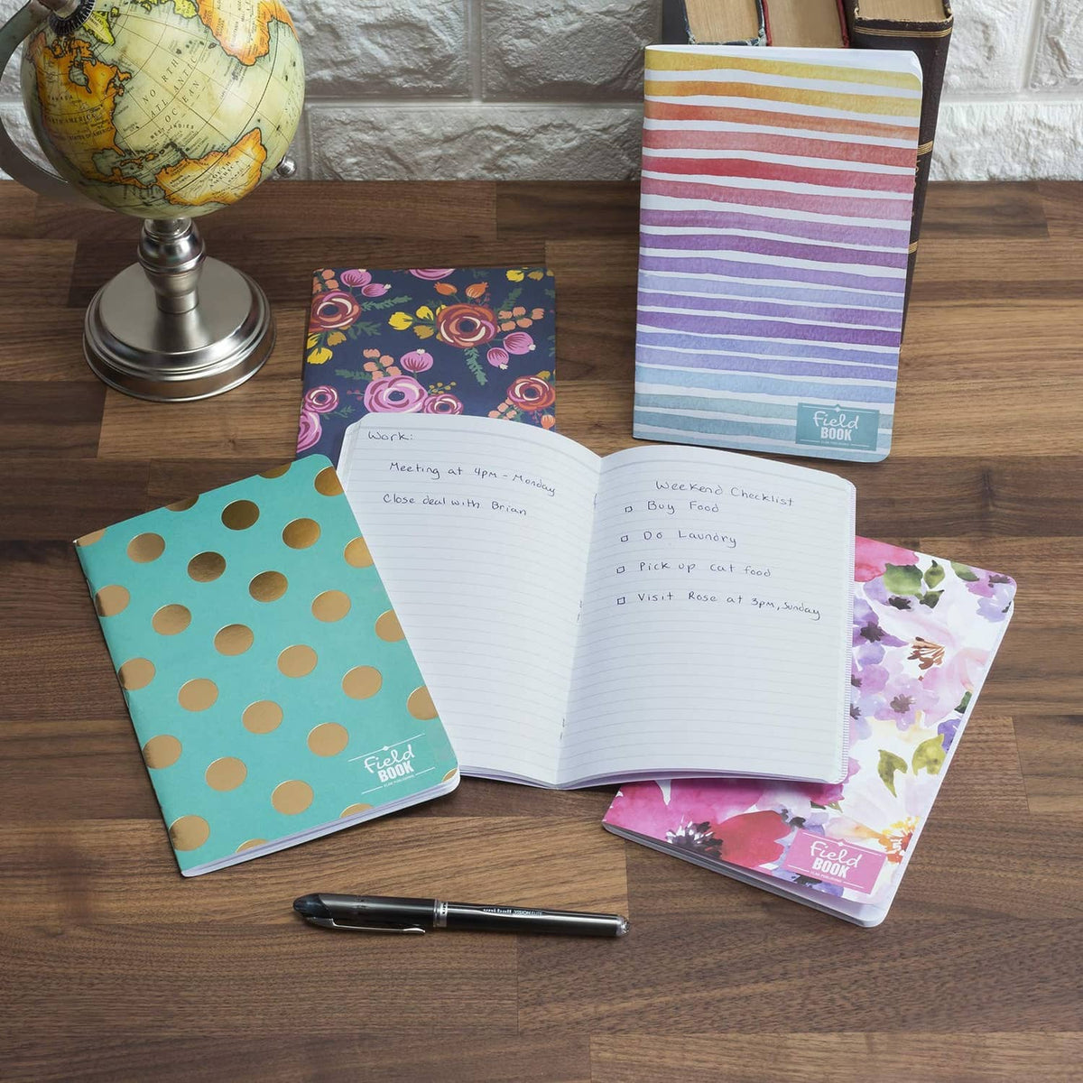 Open 5x8 ruled notebooks showing lined pages and patterned covers
