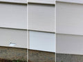 Mendyl vinyl siding repair kit: white vinyl siding with small damaged spot near bottom