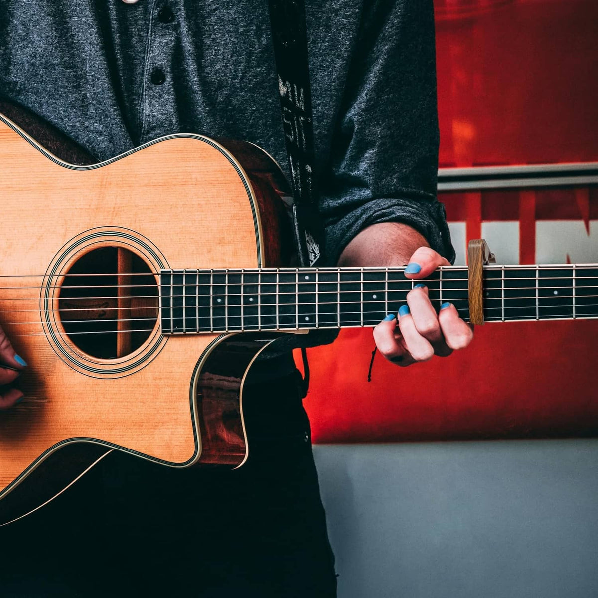 Acoustic guitar being played, hand near fretboard