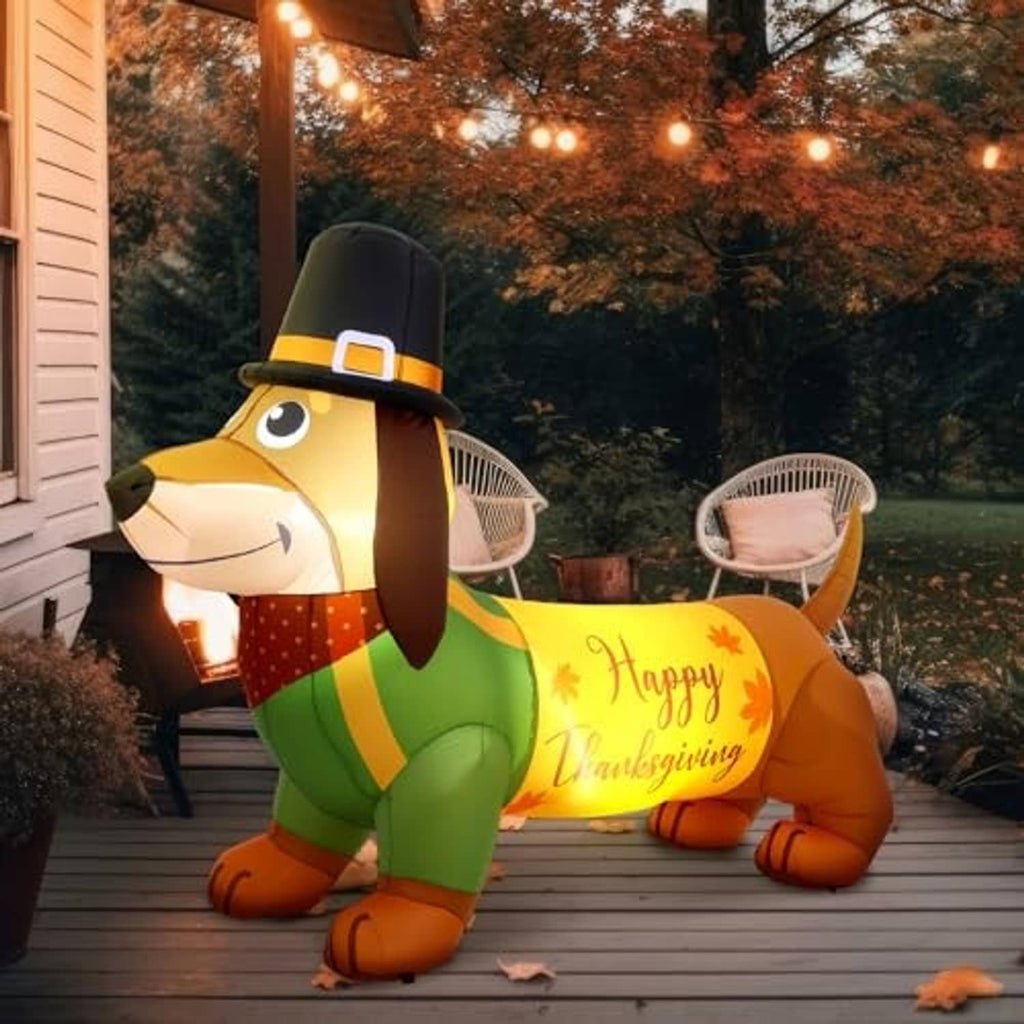 Inflatable dachshund Thanksgiving decoration on porch with top hat and “Happy Thanksgiving” sign
