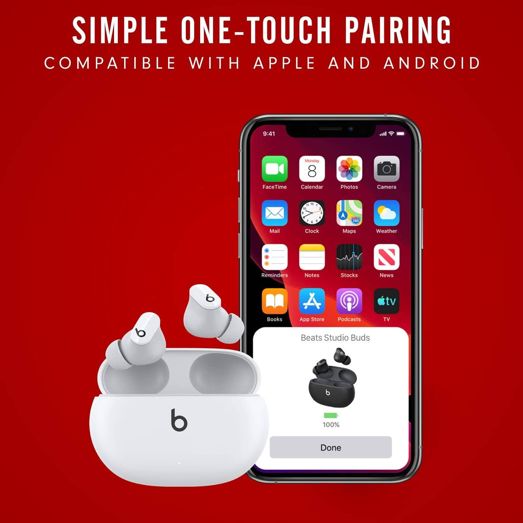 White true wireless earbuds with charging case beside a smartphone for pairing