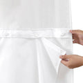 White snap-in shower curtain liner with top snap buttons and hand holding the edge