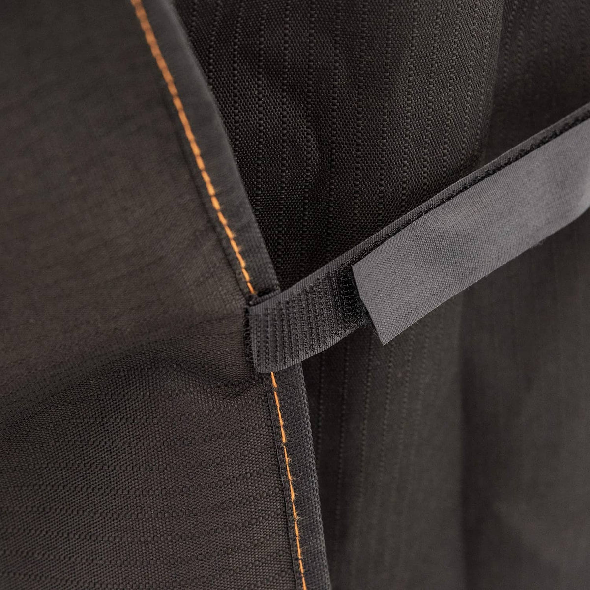 Black smoker cover attachment strap with orange-stitch edging and reinforced panel