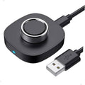 Black charging dock with circular top and USB cable for smart ring charging