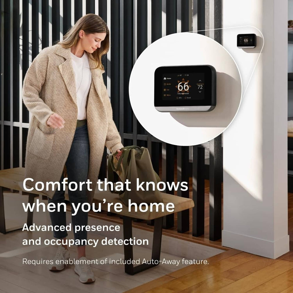 Wall-mounted smart thermostat with black housing and touchscreen temperature display