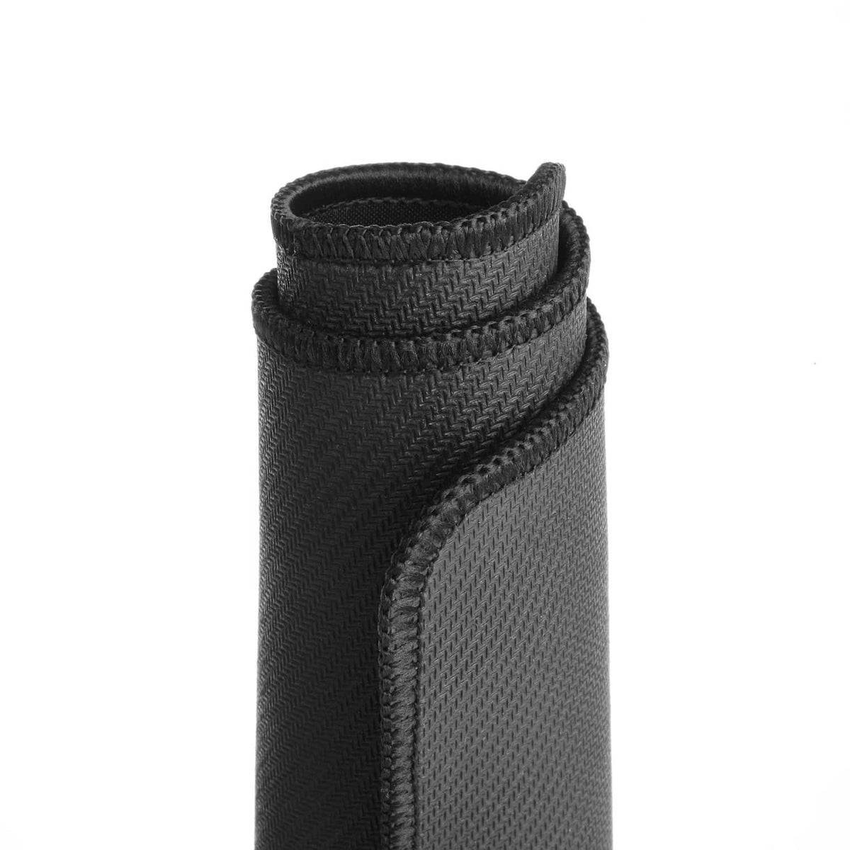 Black mouse pad close-up of rolled hem edge with tight woven texture.