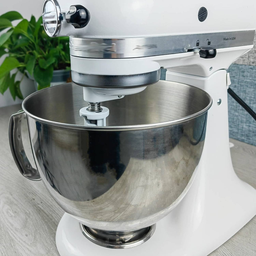 Chrome mixer beater attachment with installed spring and washer hardware on stand