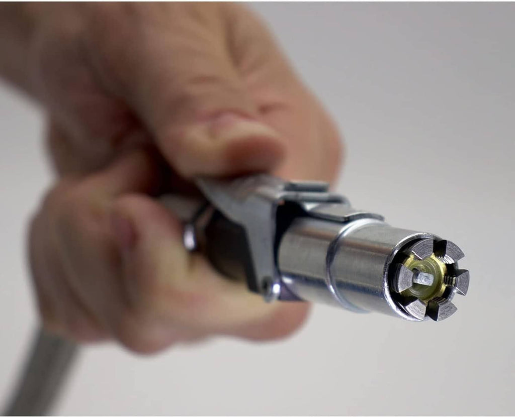 Hand holding a tire inflator air chuck connector with steel jaws