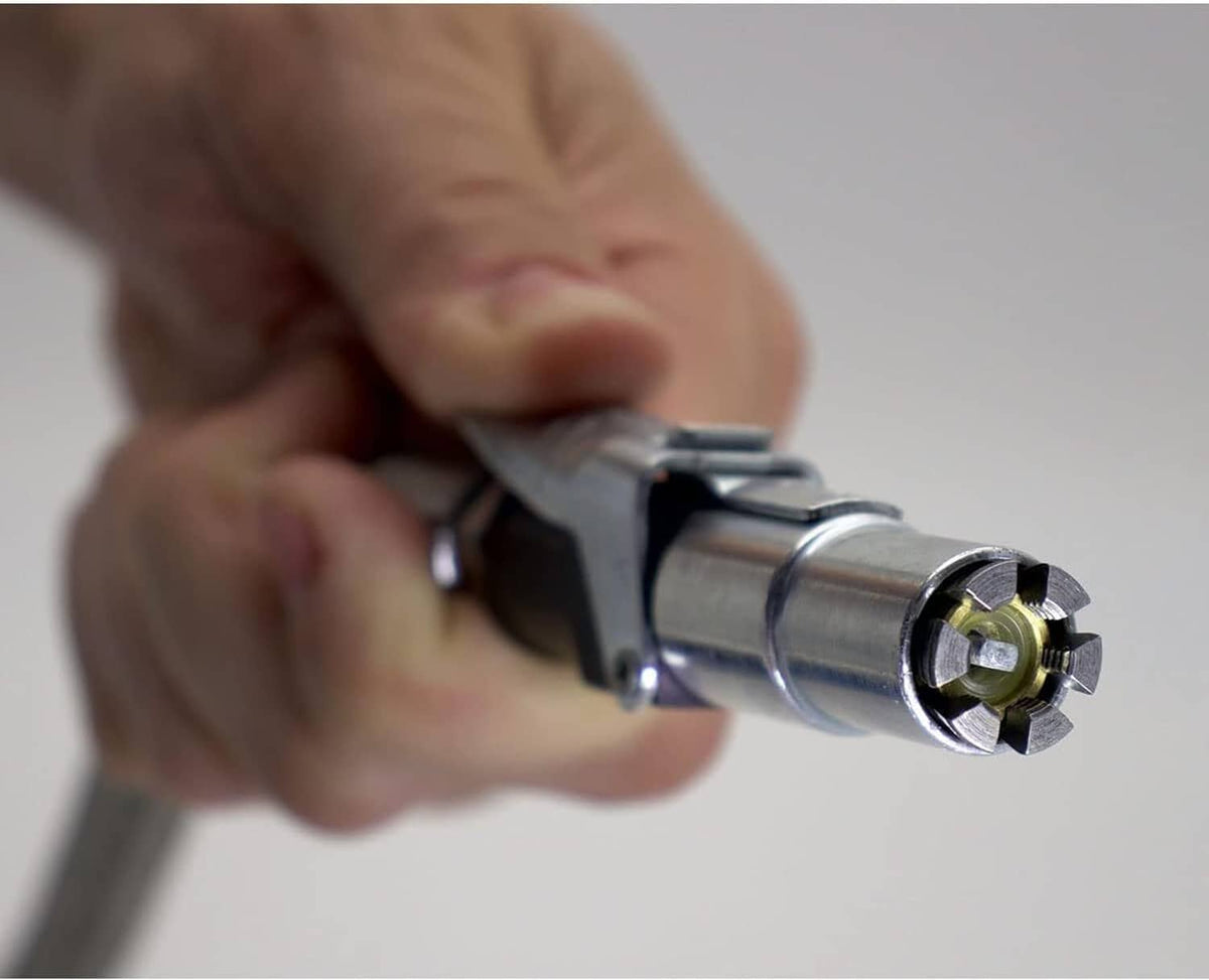 Hand holding a tire inflator air chuck connector with steel jaws
