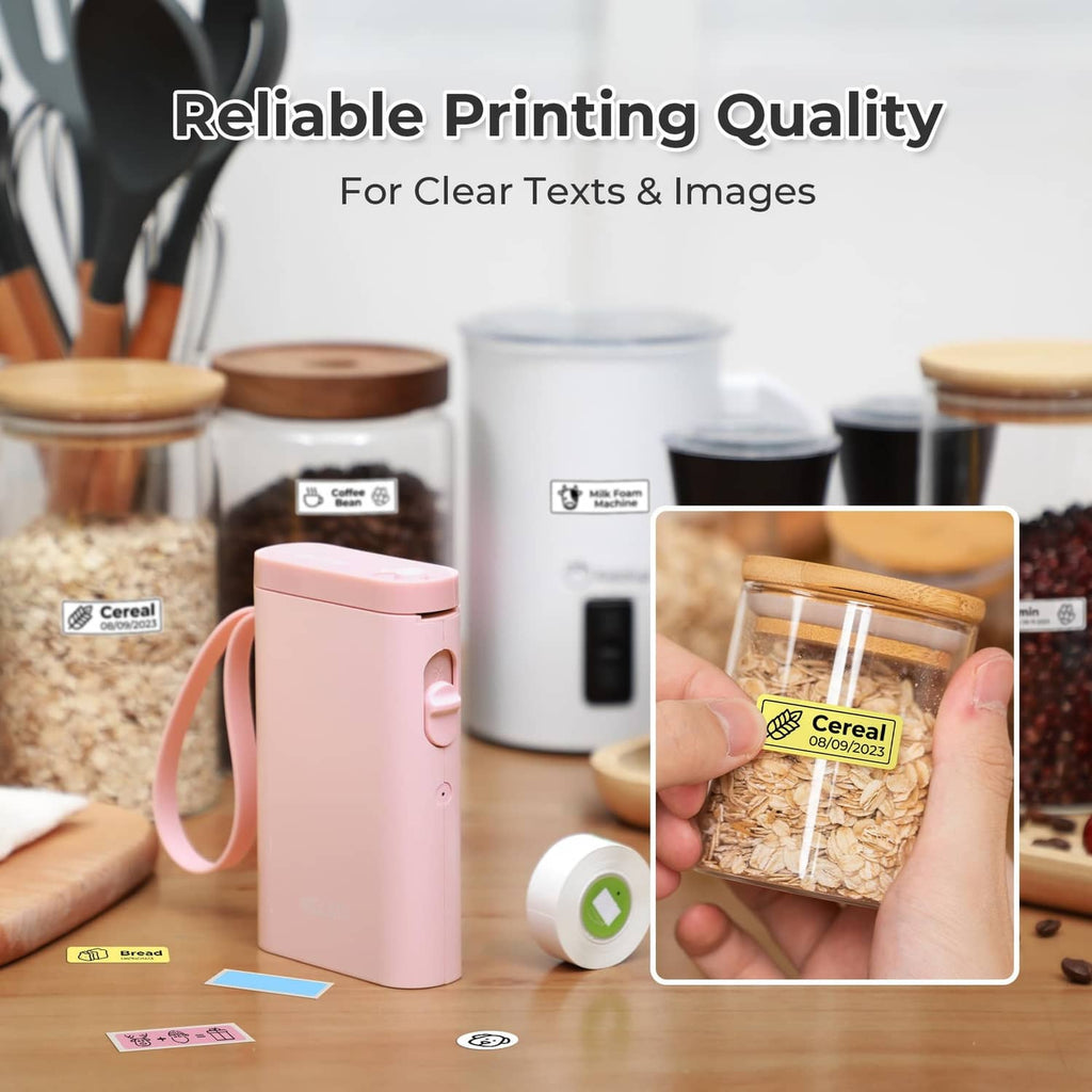 Pink label maker printer with clear label printing samples on table