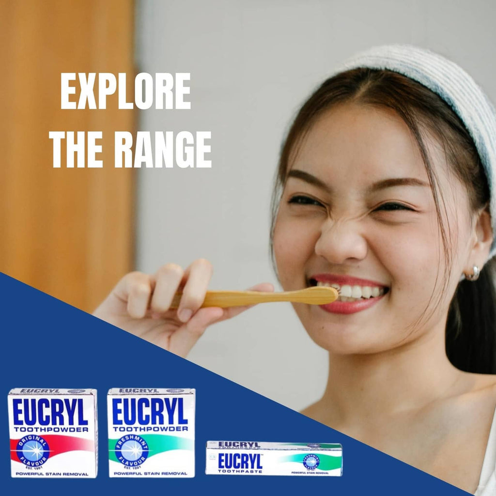Smiling woman brushing teeth with Eucryl toothpowder range boxes