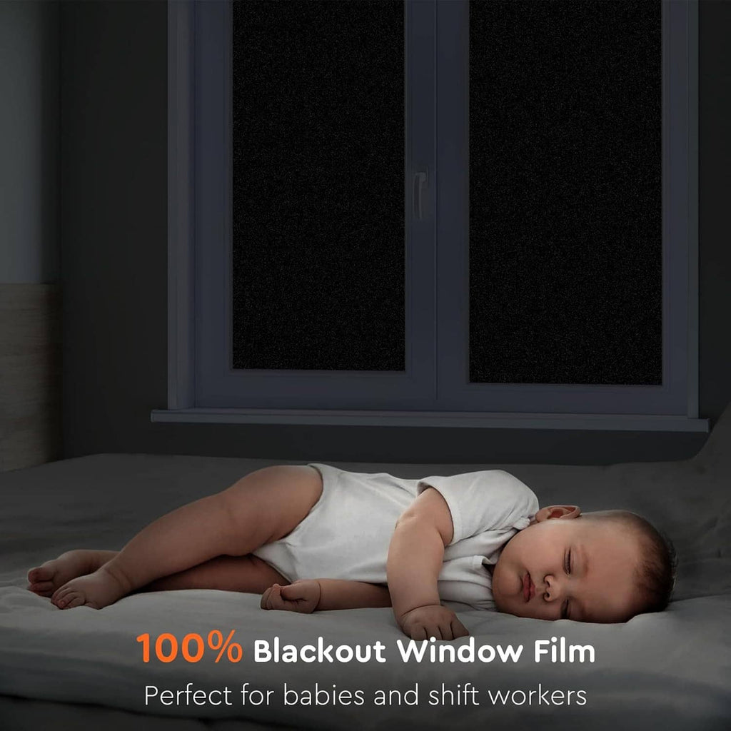 Blackout window film covering dark window panels to block light for privacy