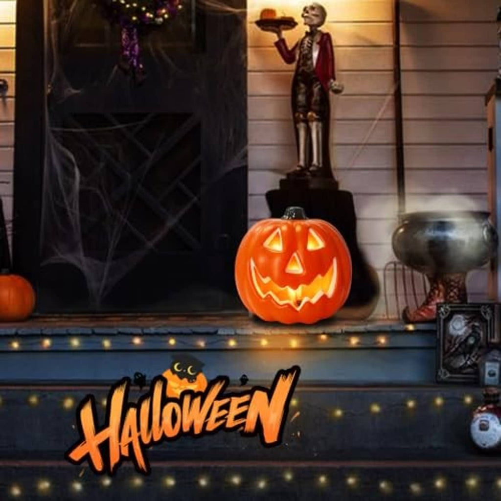 Glowing orange LED jack-o-lantern pumpkin on a porch ledge