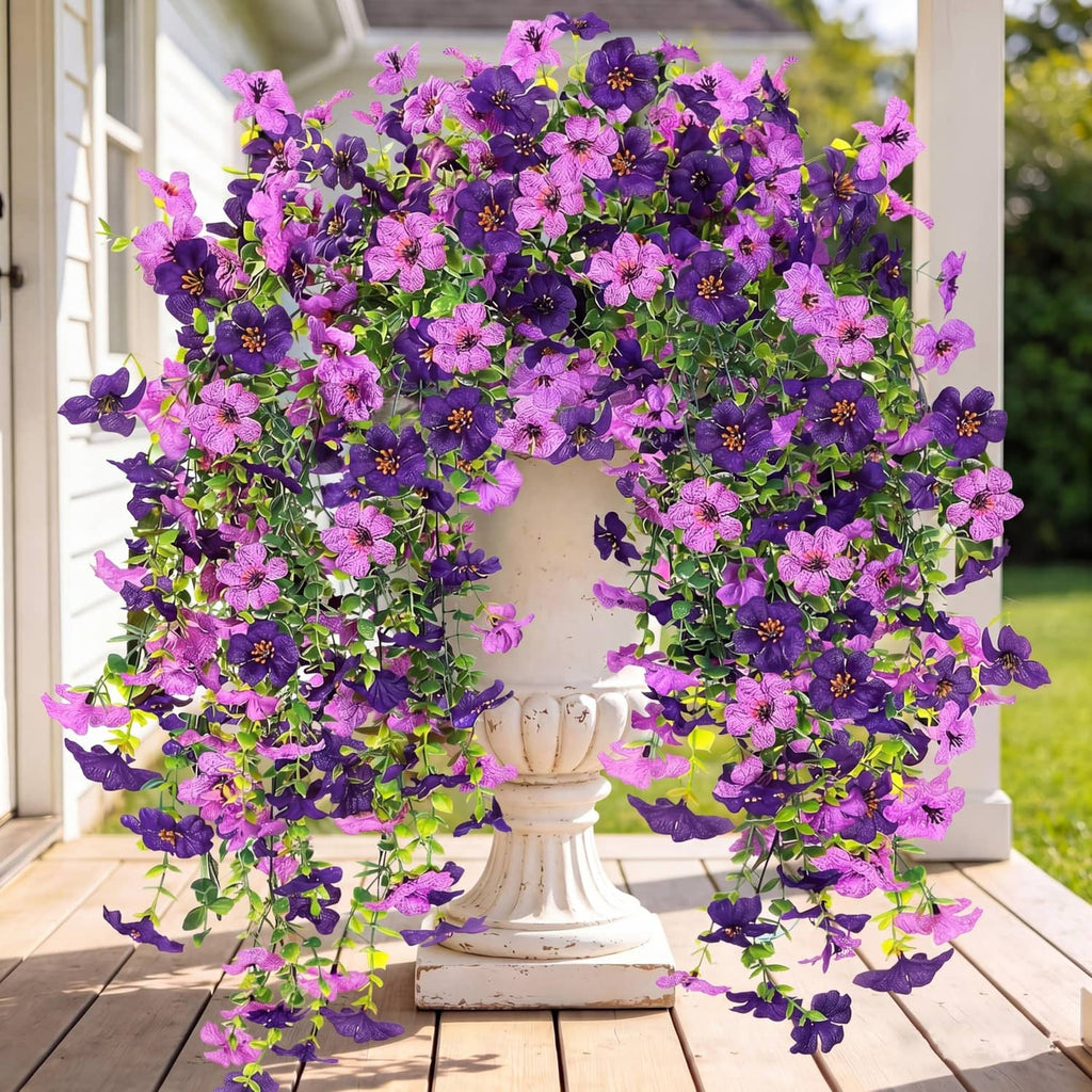 Purple and magenta artificial hanging flower wreath with trailing faux blooms