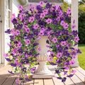 Purple and magenta artificial hanging flower wreath with trailing faux blooms