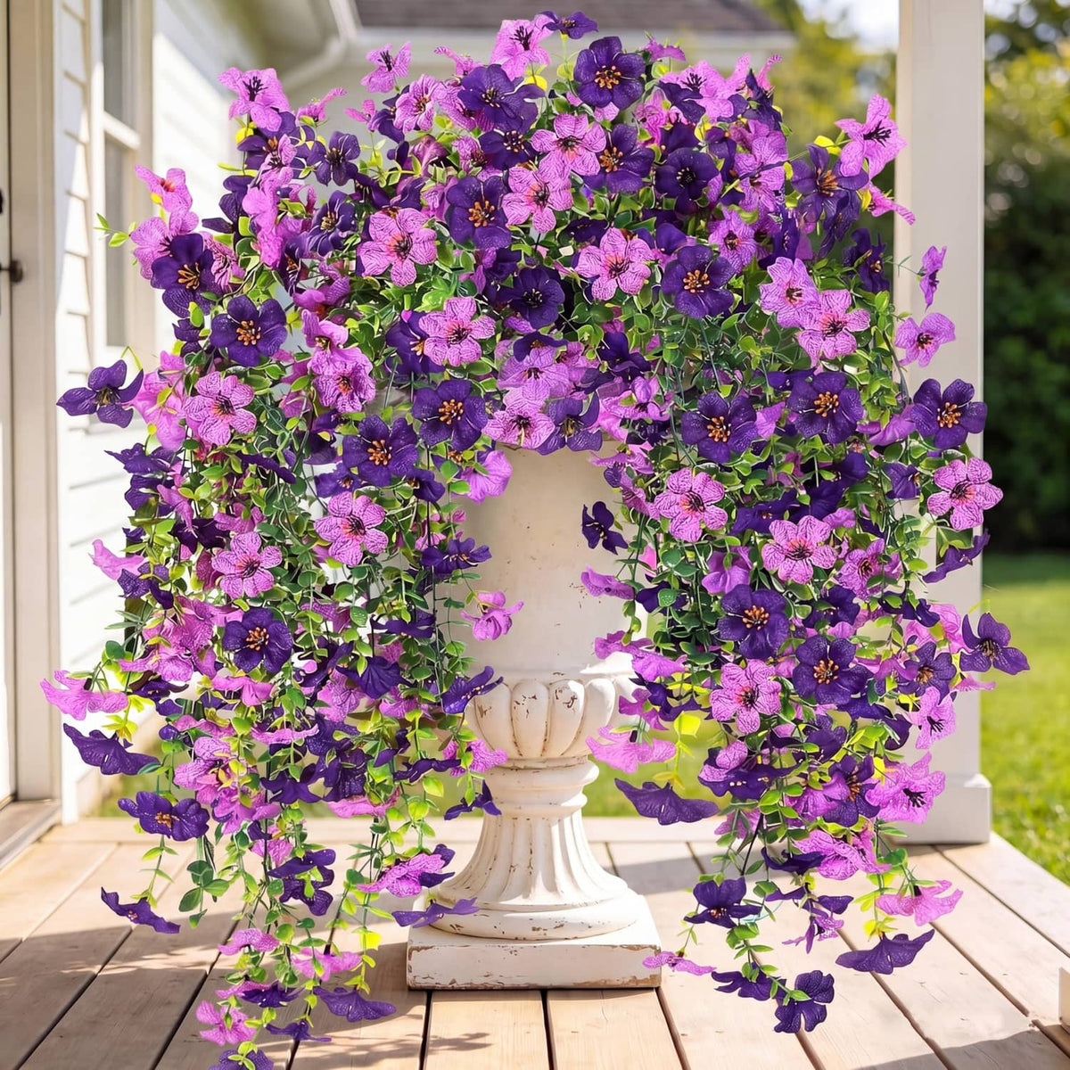 Purple and magenta artificial hanging flower wreath with trailing faux blooms