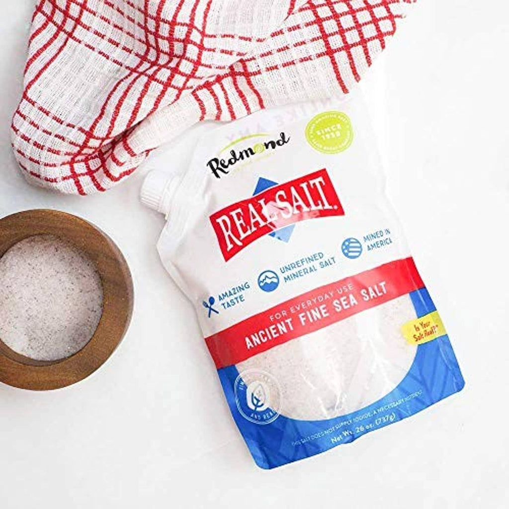 Redmond Real Salt pouch with fine sea salt and a wooden bowl