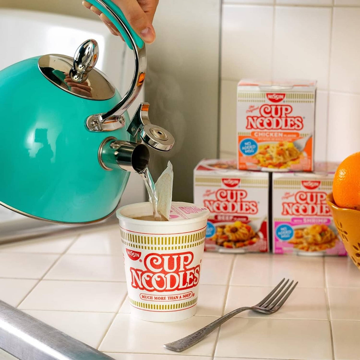 Nissin chicken-flavor Cup Noodles cup with pouring water, spoon and fork