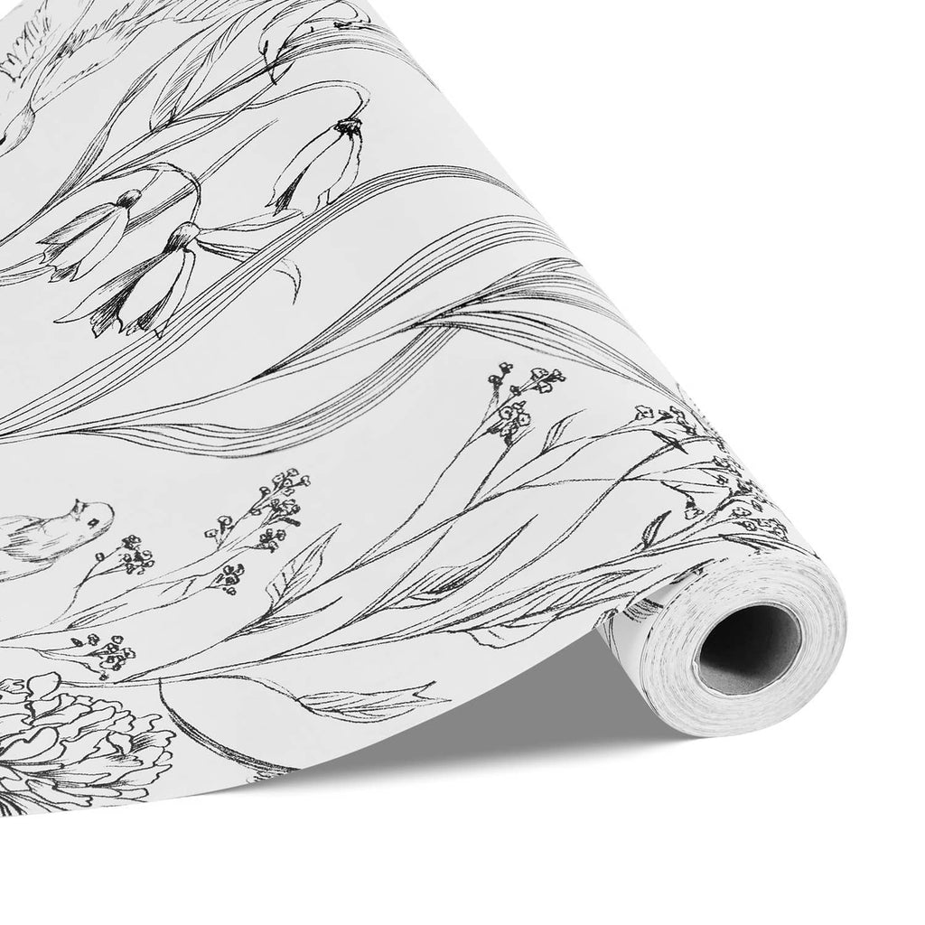 Self-adhesive wallpaper roll close-up showing black botanical line details on white