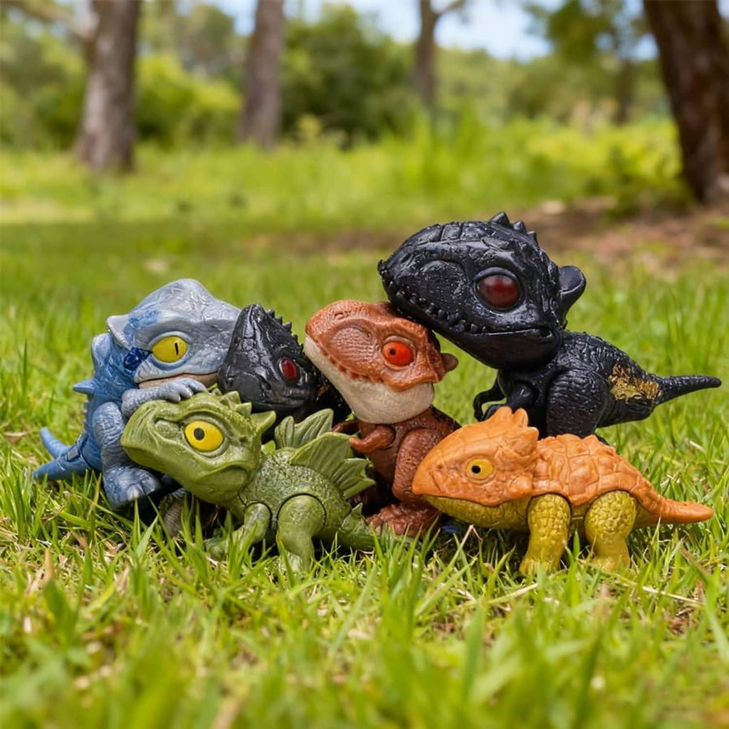 Assorted biting finger dinosaur toy figures grouped together on grass