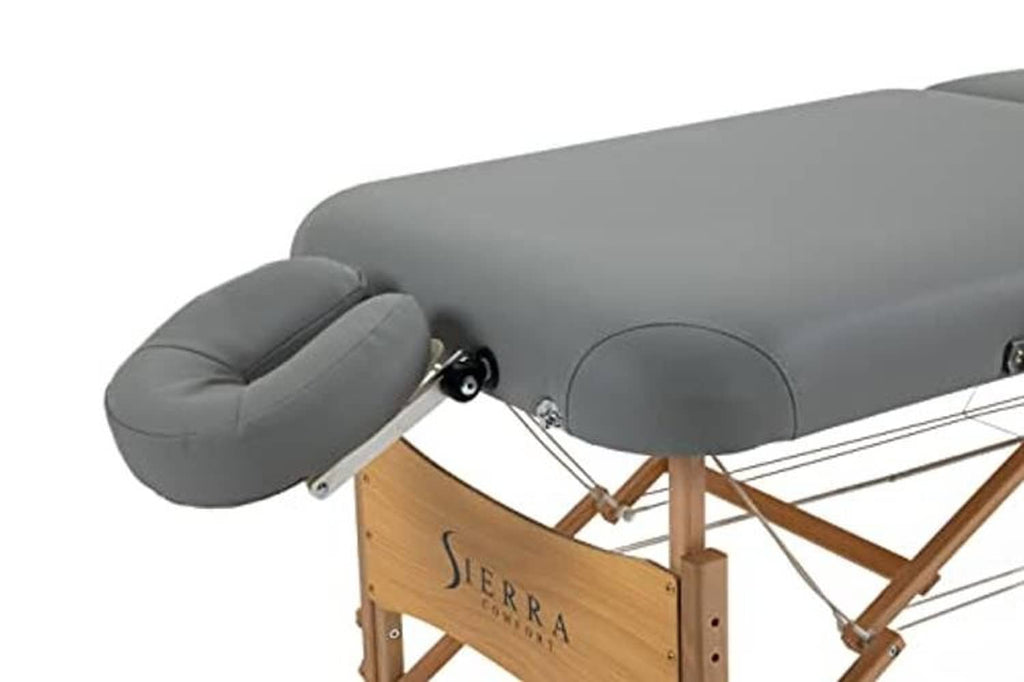 Gray face cradle and headrest on a wooden folding massage table frame