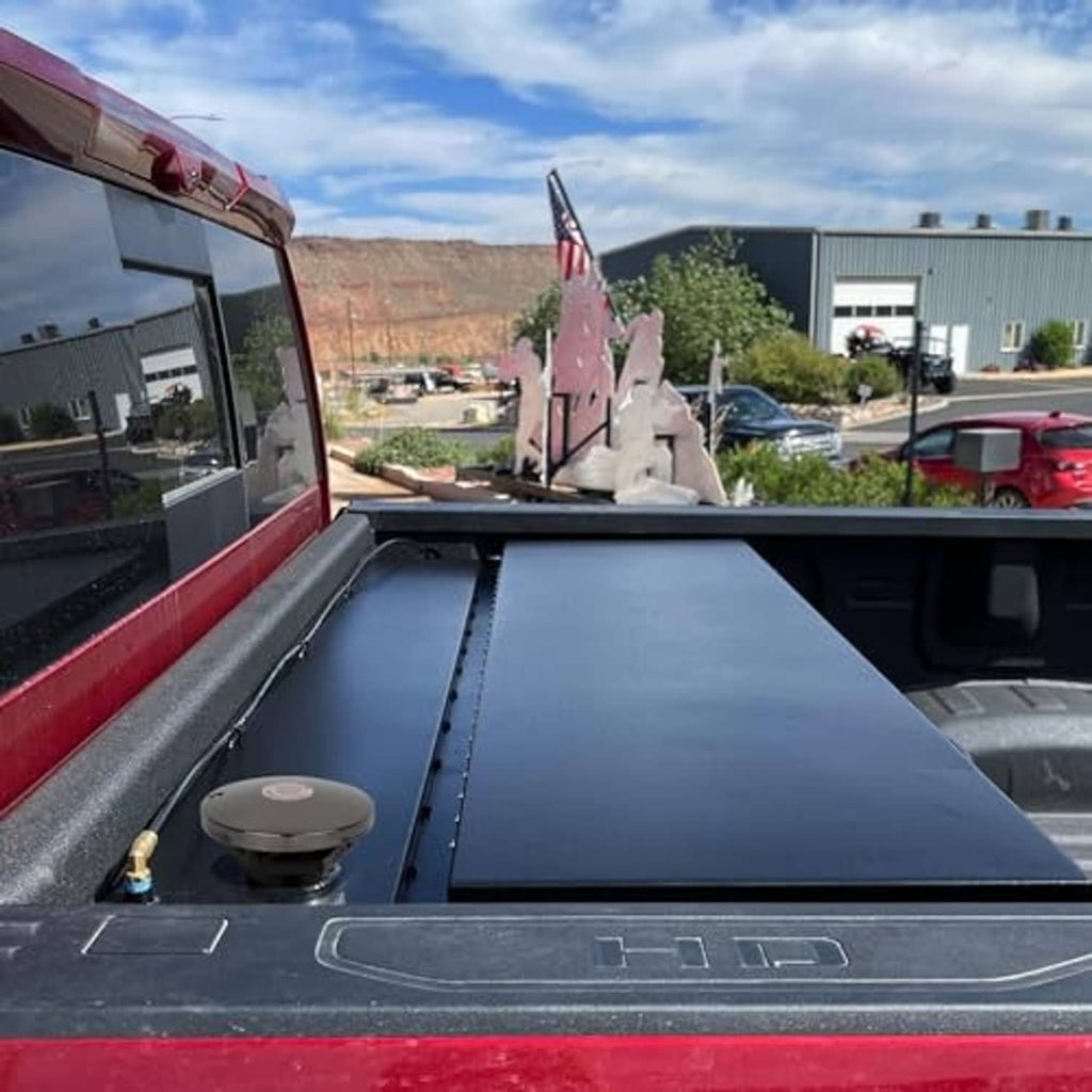 Vented fuel transfer cap on open truck bed panel, ready for fueling