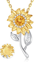 Gold-tone flower sun pendant on sterling silver spinner bail with clear stone ring