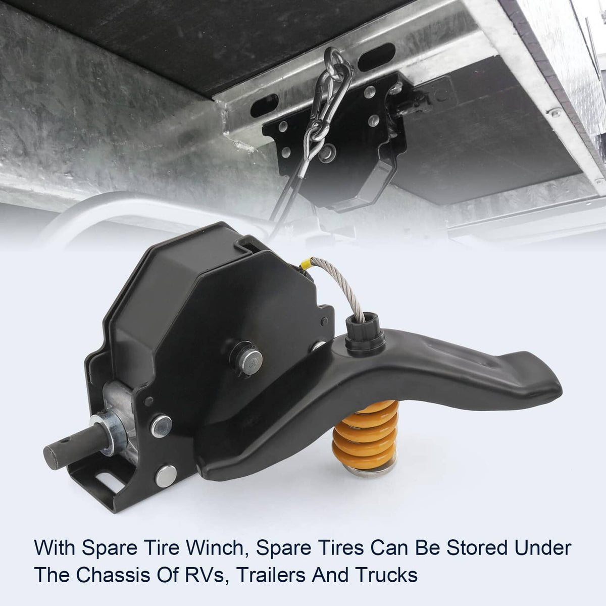 Mounted black spare tire winch with orange coil spring handle under RV chassis