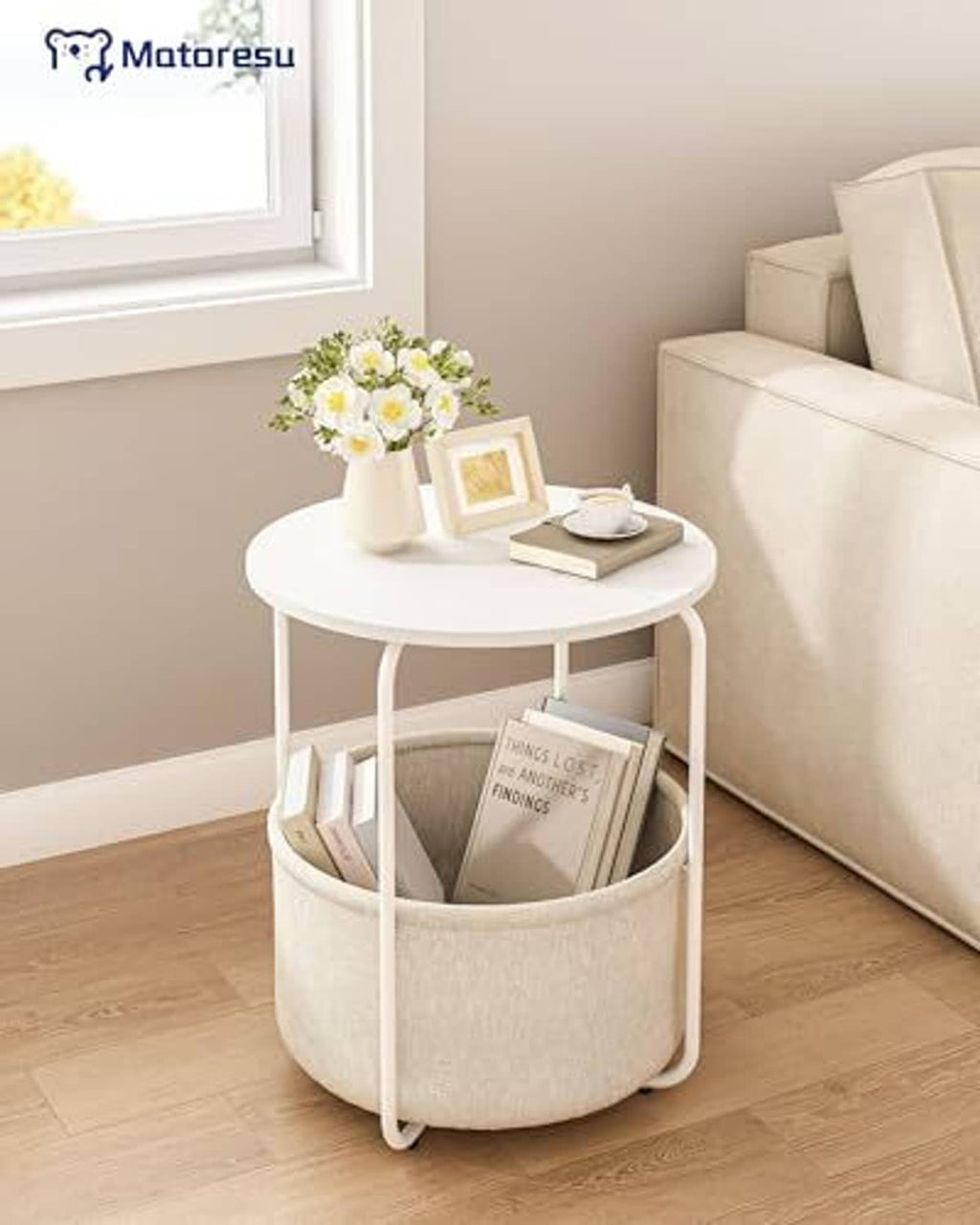 White round end table with beige fabric storage drum, open top with books inside