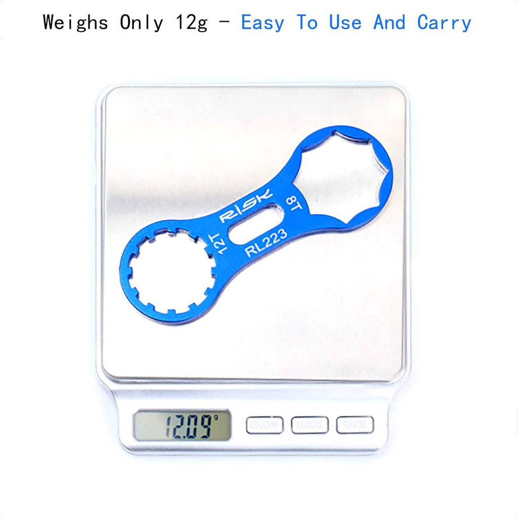 Blue bicycle fork cap spanner wrench shown on a digital scale, notched socket and loop.