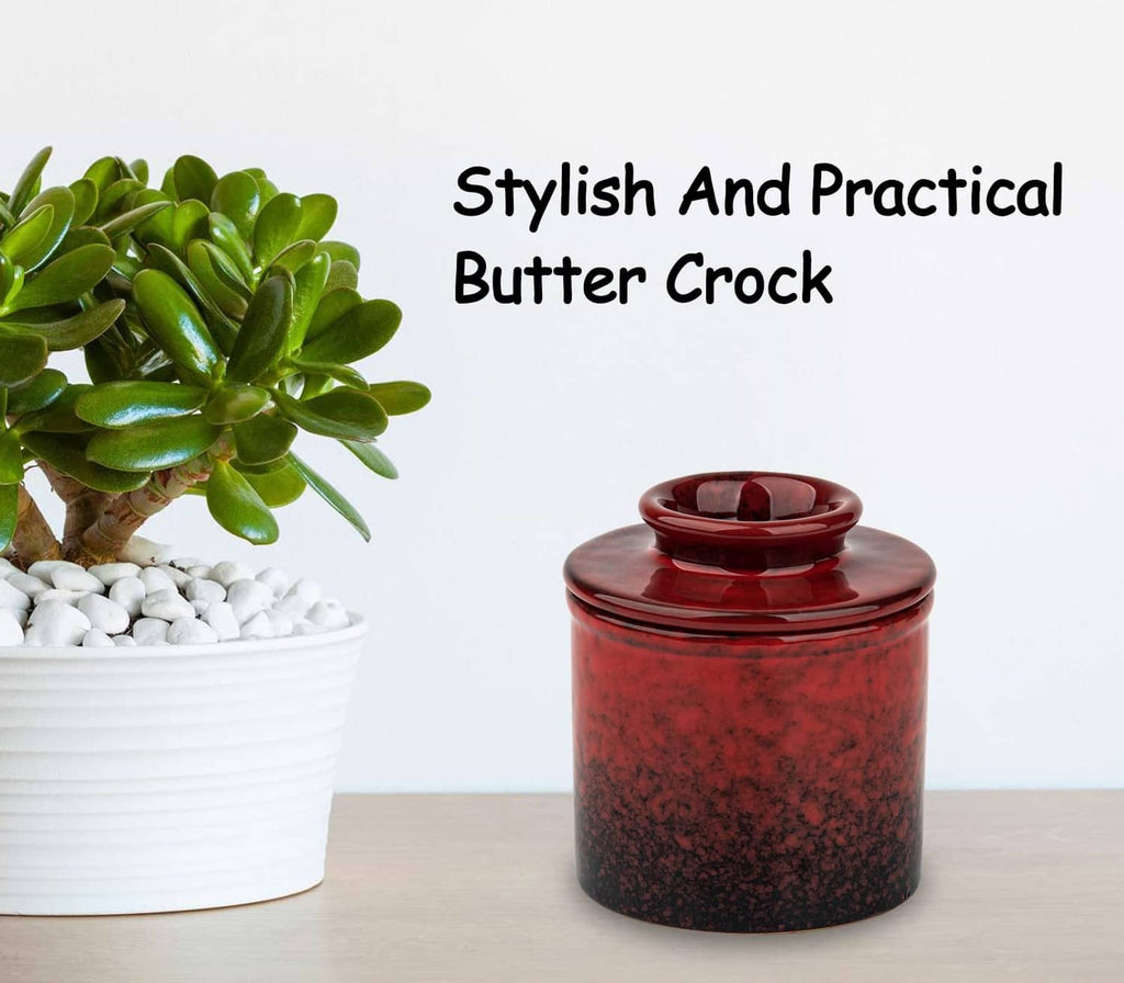 Red speckled ceramic butter crock with domed lid, on tabletop.