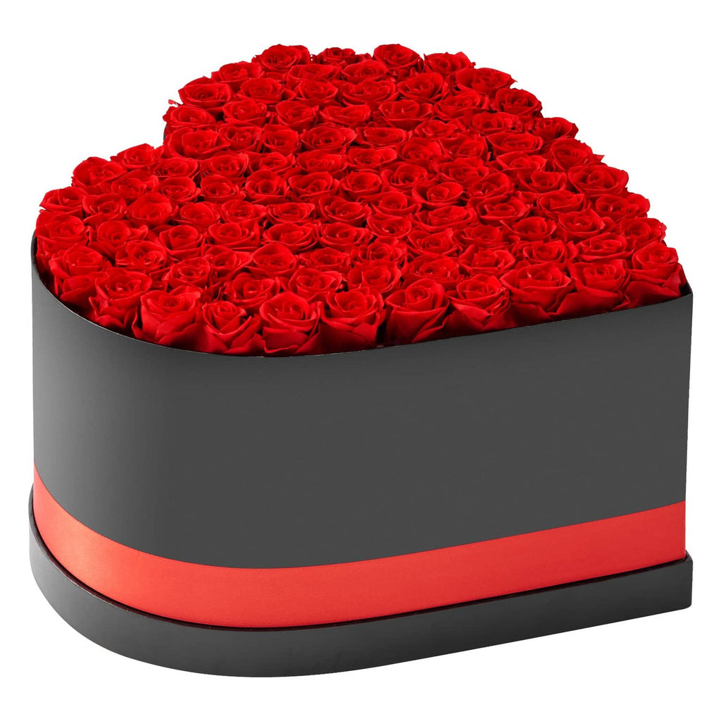 Heart-shaped rose box with red preserved roses in gray container and red ribbon band.